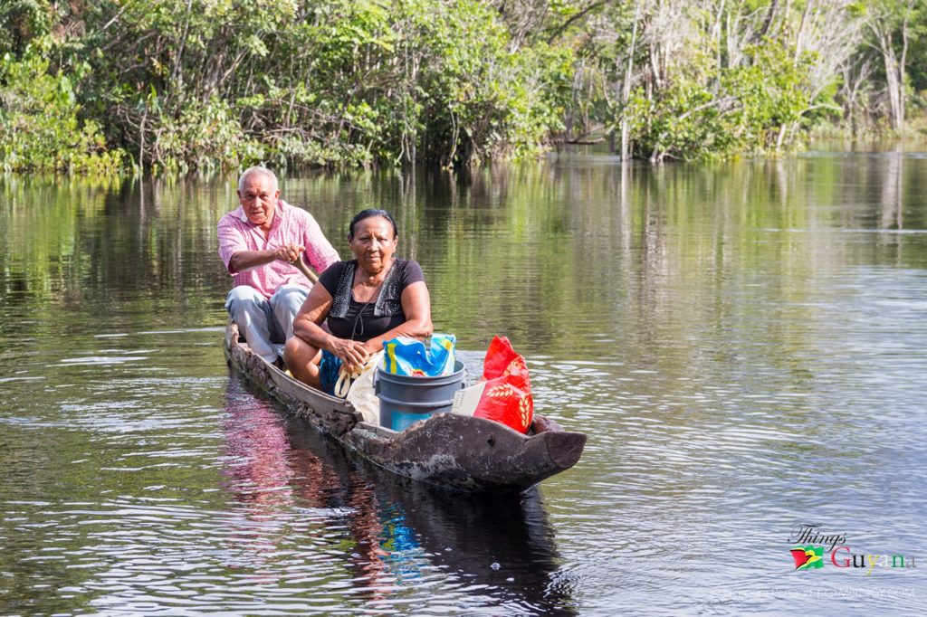 Mr. Dundas and his wife in a their dug-out canoe. 